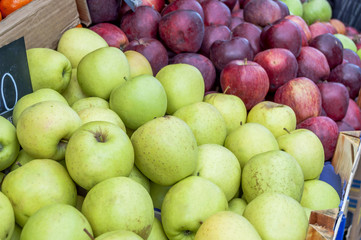 Delicious green and purple apples in supermarket