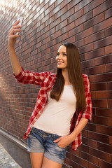 Girl making selfie photo and shwing her tongue