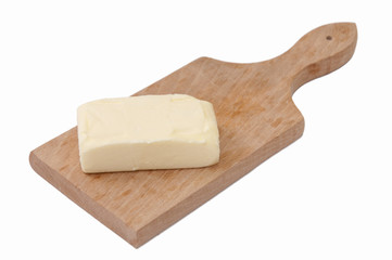 Slice of butter on the wooden board
