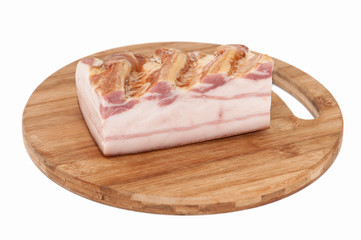A piece of smoked bacon on wooden board
