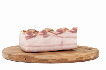 A piece of smoked bacon on wooden board