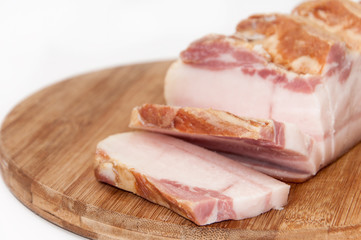 Sliced smoked bacon on the wooden board