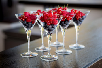 Many glasses of blueberry, raspberry, currant