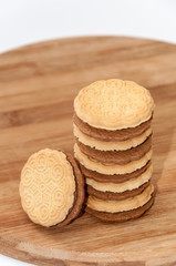 Chocolate sandwich biscuits on the wooden board
