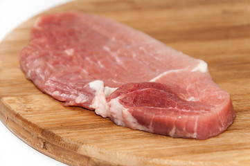 Pork tenderloin on a kitchen wooden board