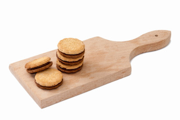 Fototapeta na wymiar Chocolate sandwich biscuits on the wooden board