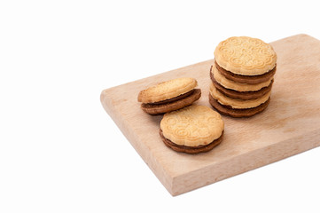 Chocolate sandwich biscuits on the wooden board