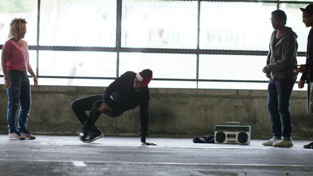4K Two breakdancers take turns to perform windmill spins as friends watch on, shot on Red Epic Dragon