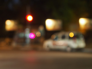 Defocused silhouette of the car and traffic lights
