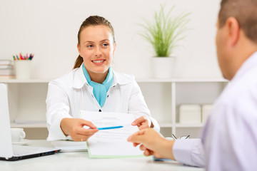 Fototapeta premium Bank clerk is offering her client a loan agreement to sign.