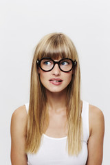 Beautiful but unsure young blond student in glasses