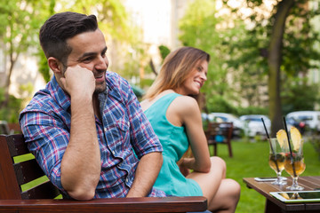 Couple sitting on the bench and laughing