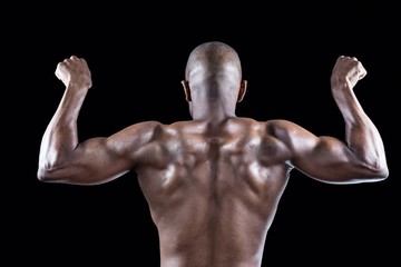 Fototapeta na wymiar Rear view of muscular athlete posing