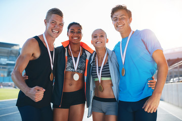 Happy multiracial athletes celebrating victory
