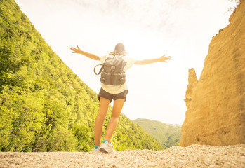 Hiker - young hiker raises her arms to the sky in front of the mountain. Caucasian woman - people,...