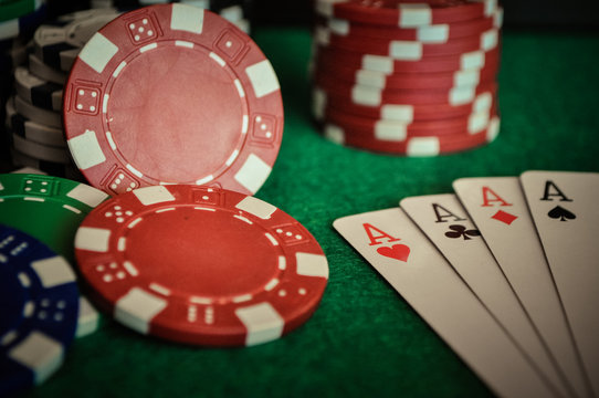 Poker Chips on a gaming table with cards