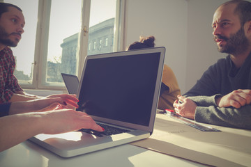 Young group of people/architects discussing business plans.