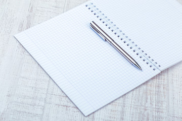 Empty notepad with pen on a desk