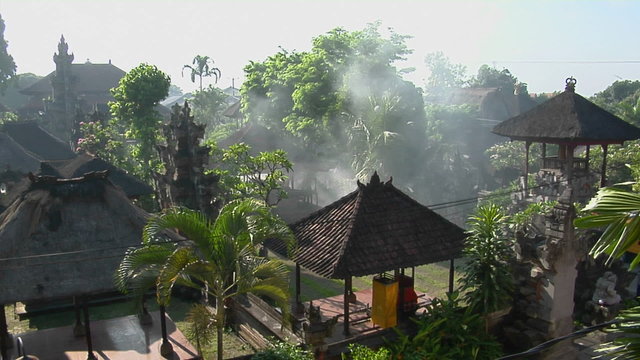 Smoke rises from the middle of the Balinese village in Indonesia.
