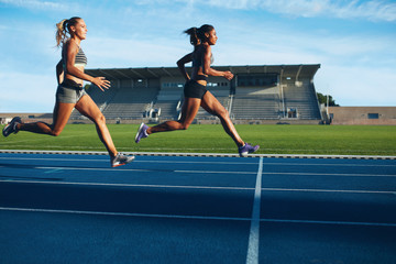 Athletes arrives at finish line on racetrack