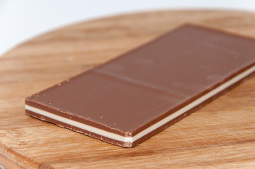 Brown white chocolate on a wooden board