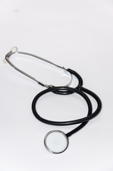 The medical stethoscope on a white surface