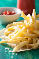 french fries with ketchup over green background