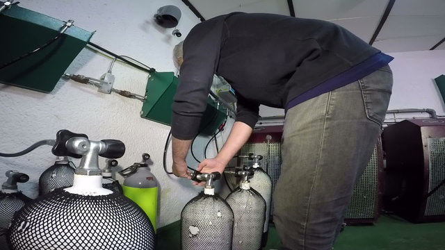 Man Refilling Scuba Diving Air Tanks