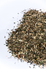 A bunch of nettle tea over white surface