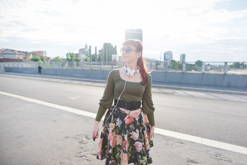 young handsome redhead woman listening music