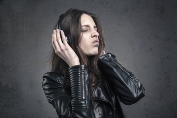 young Woman with head phones listening to music and Singing