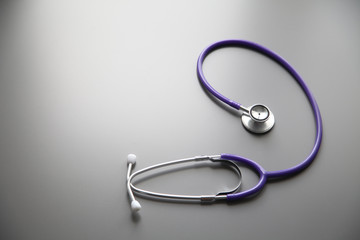 Stethoscope on the grey desk, close up