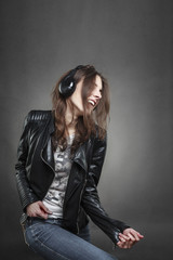 Fototapeta premium Woman dancing while listening to music with headphones