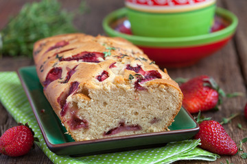Homemade yogurt cake with fresh strawberries and thyme