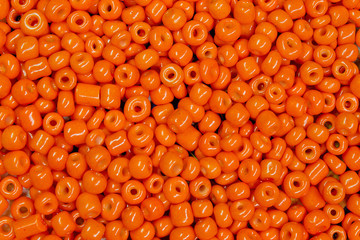 background of scattered orange beads close up