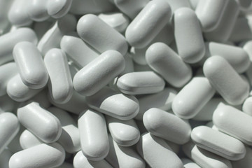 heap of white pills close up