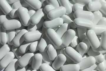 heap of white pills close up