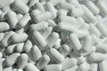 Fototapeta na wymiar heap of white pills close up