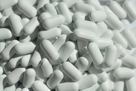 heap of white pills close up © lord_photon