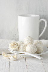 Coconut candies pile in white plate and cup