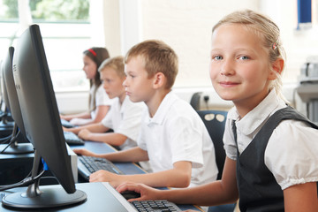 Group Of Elementary Pupils In Computer Class With Teacher