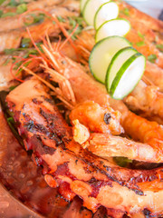 plate with grilled prawns shrimps and vegetables and octopus