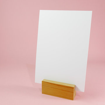 Blank menu card with wooden standing dock on pink background. (#2)