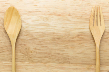 Wooden spoon and fork on wood background