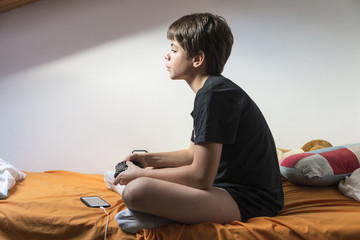 Boy playing video games at home © jordi2r