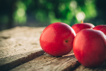 Apples on wooden table over summer bokeh background