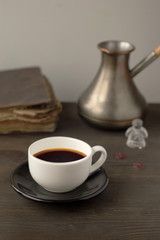 cup of coffee on a background of the Turks and books on a wooden