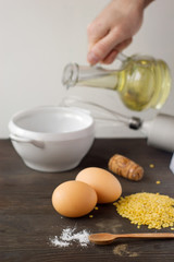 Food ingredients and kitchen utensils for cooking on wooden back