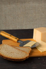 half a bun with cheese and blurry bread rolls in the background