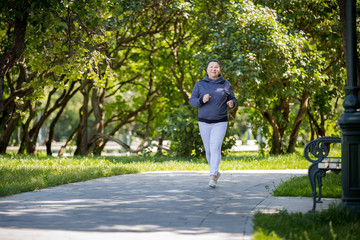 Mature woman jogging in the park. Healthy lifestyle